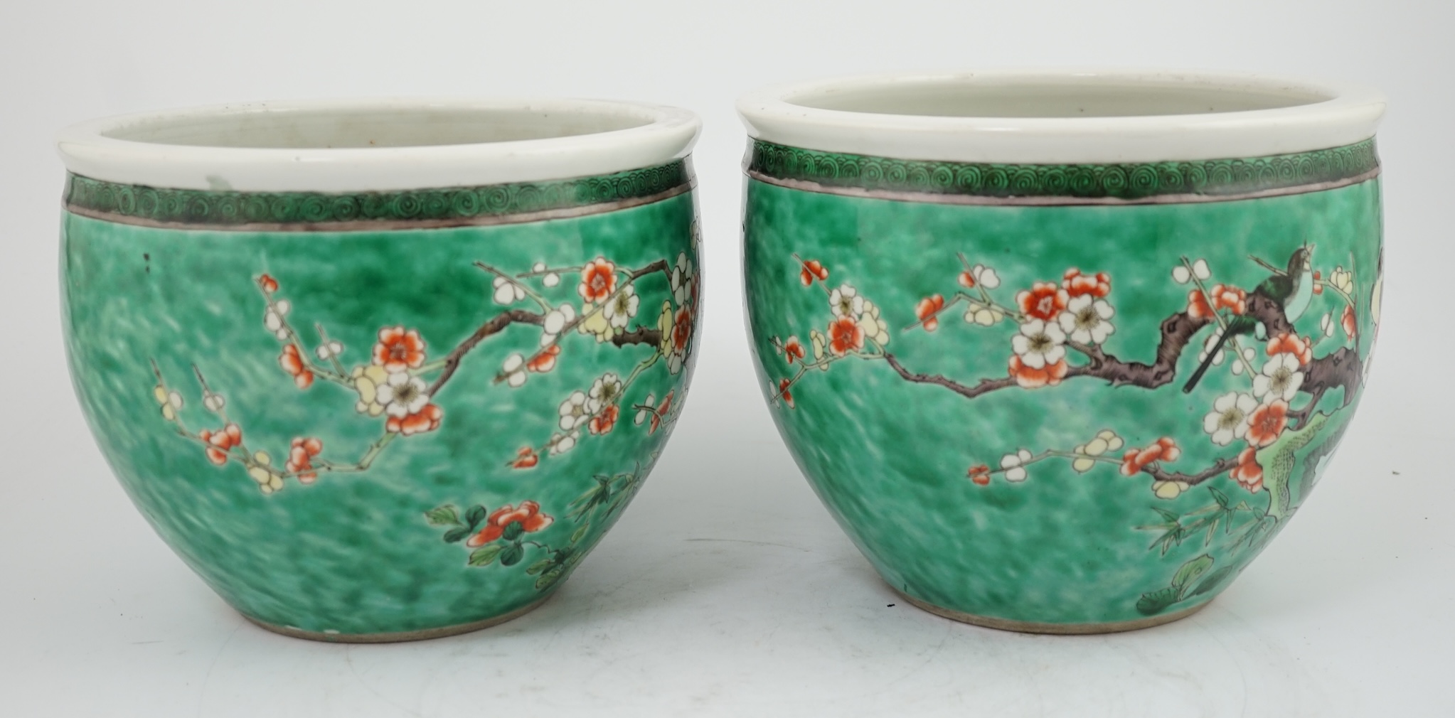 A pair of Chinese famille verte green ground jardinieres, Kangxi marks, but late 19th century